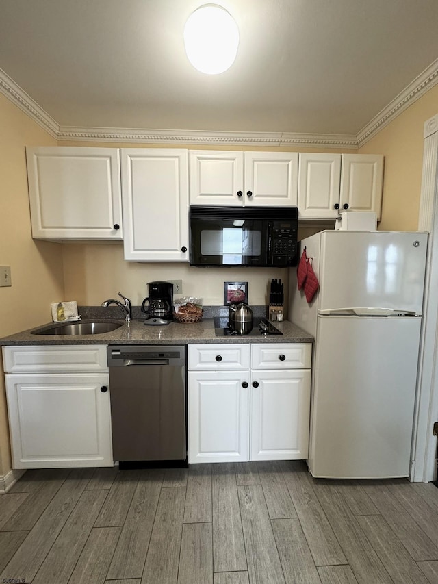 kitchen with sink, white cabinets, black appliances, and ornamental molding