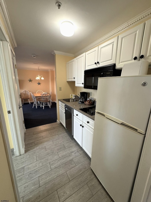 kitchen featuring sink, black appliances, white cabinets, and ornamental molding