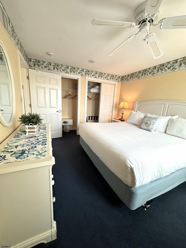 carpeted bedroom featuring multiple closets and ceiling fan