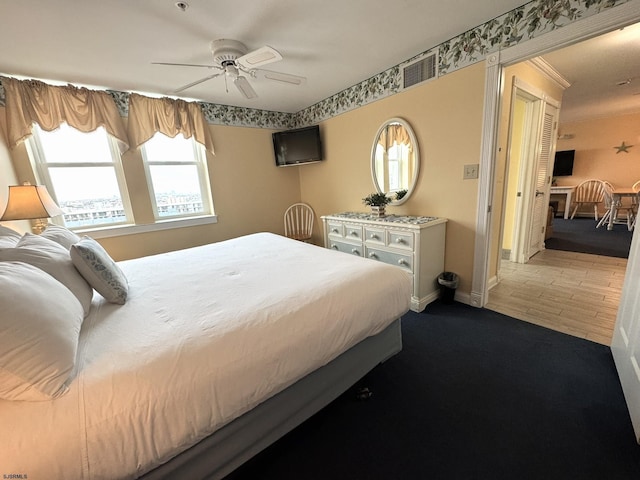 bedroom with wood-type flooring and ceiling fan