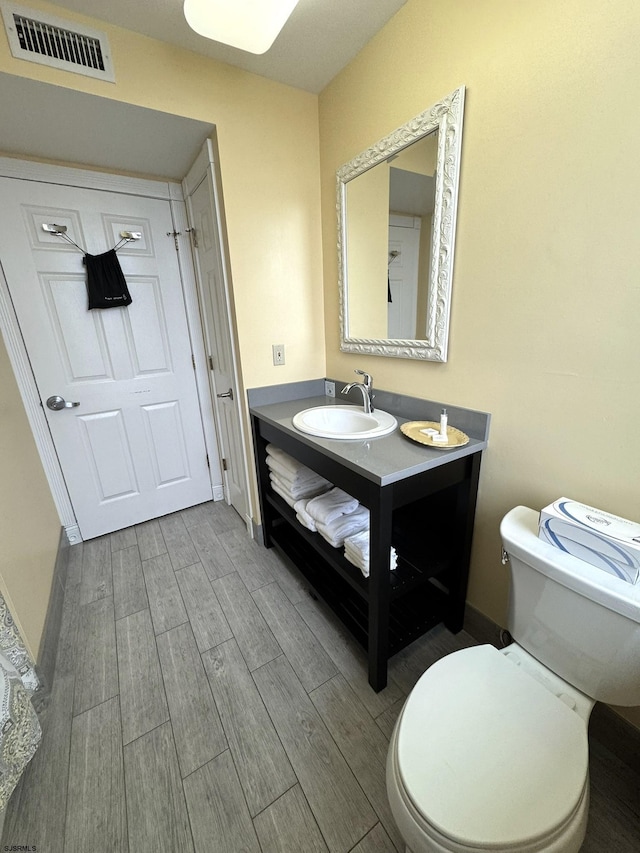 bathroom with toilet and vanity