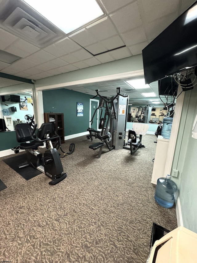 exercise room with carpet and a drop ceiling