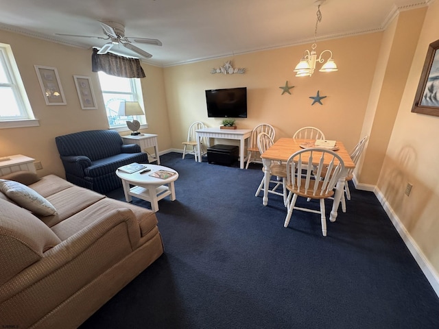 living room featuring crown molding, ceiling fan with notable chandelier, and dark carpet