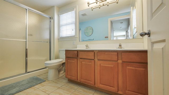 full bath with tile patterned flooring, toilet, double vanity, a stall shower, and a sink