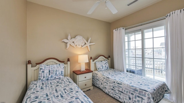 bedroom with light carpet, visible vents, and a ceiling fan