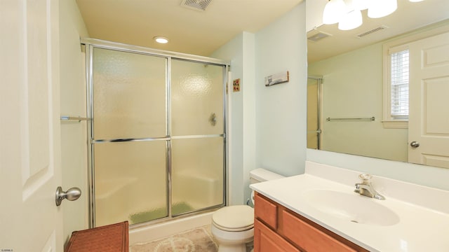 full bath with a shower with door, visible vents, toilet, and vanity