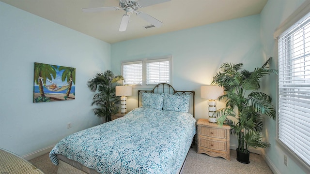 bedroom featuring visible vents, carpet floors, baseboards, and a ceiling fan