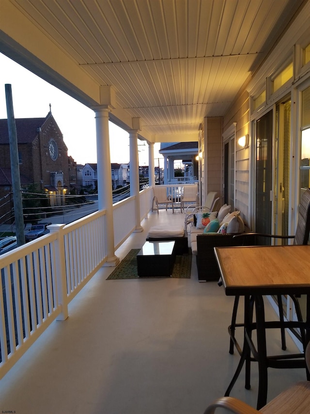 view of patio / terrace featuring a balcony and outdoor dining area