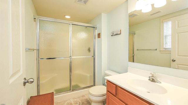 full bath featuring toilet, an enclosed shower, vanity, and visible vents