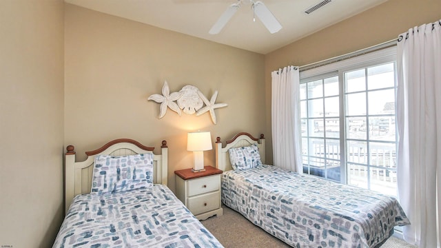 bedroom featuring light carpet, visible vents, and a ceiling fan