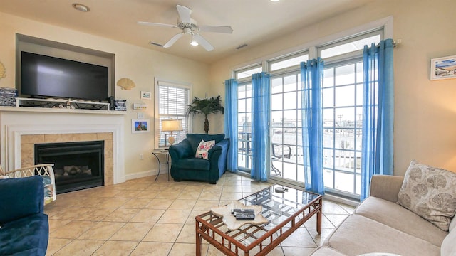 tiled living area with visible vents, baseboards, a tiled fireplace, recessed lighting, and a ceiling fan