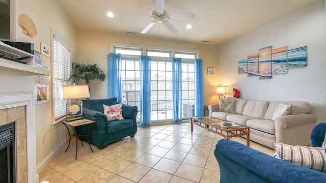 living area featuring light tile patterned floors, a fireplace, visible vents, and a wealth of natural light