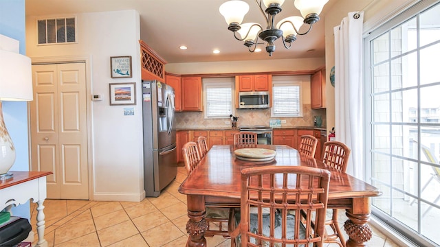 dining space with visible vents, a notable chandelier, recessed lighting, light tile patterned flooring, and baseboards