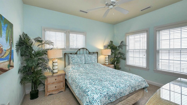 bedroom with visible vents, a ceiling fan, baseboards, and carpet floors