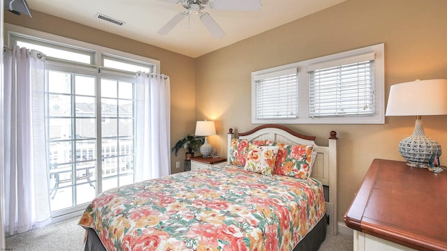 carpeted bedroom with visible vents and ceiling fan