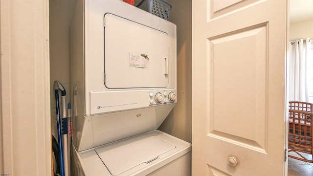 clothes washing area with laundry area and stacked washing maching and dryer