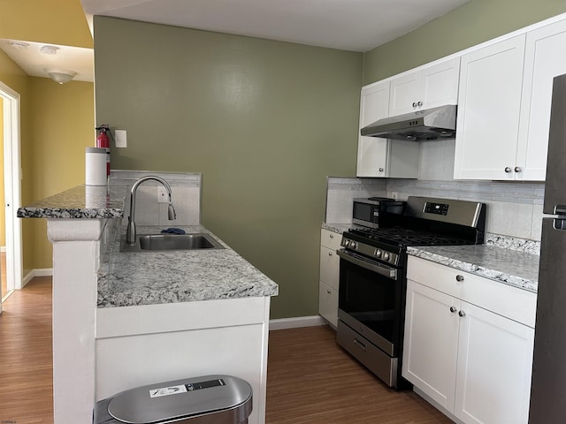 kitchen featuring sink, white cabinetry, backsplash, and stainless steel appliances