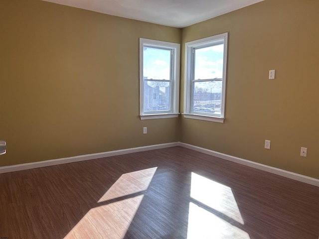 empty room with dark wood-type flooring