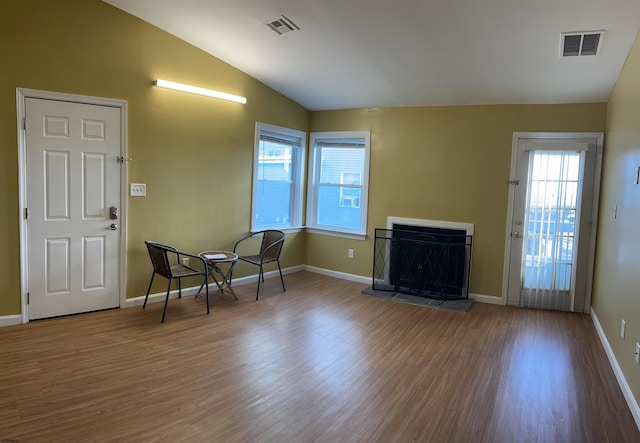 foyer with hardwood / wood-style floors and vaulted ceiling