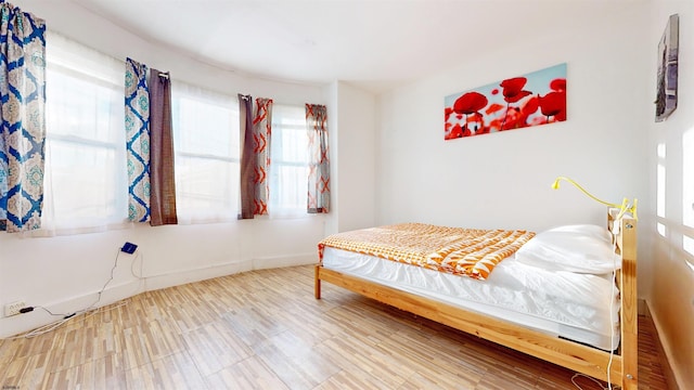 bedroom with hardwood / wood-style floors