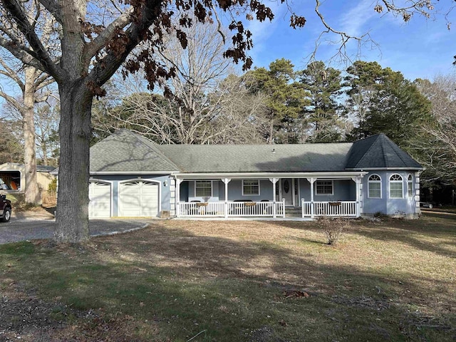 ranch-style house with a garage, covered porch, and a front yard