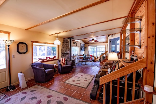 living room with beamed ceiling, ceiling fan, and tile patterned flooring