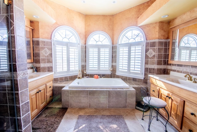 bathroom with tile walls, vanity, and tile patterned flooring