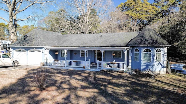 single story home with a garage and a porch