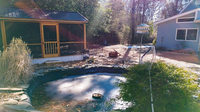 view of pool with a sunroom