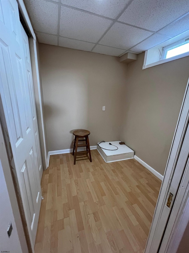 clothes washing area featuring light hardwood / wood-style floors