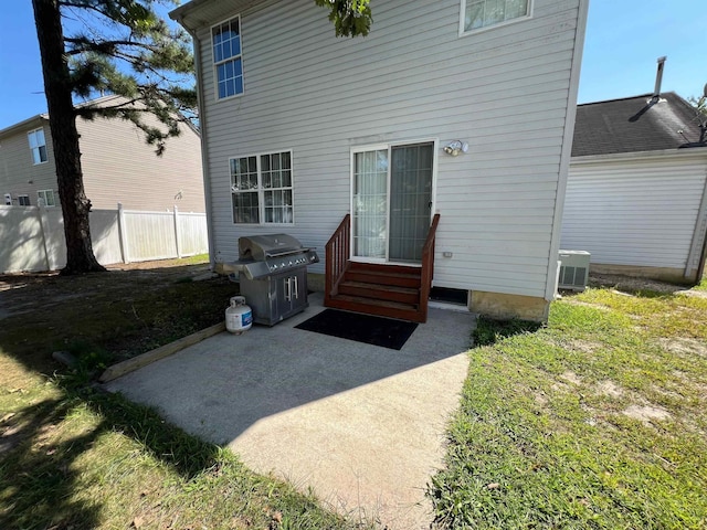 back of property featuring central AC unit, a yard, and a patio area