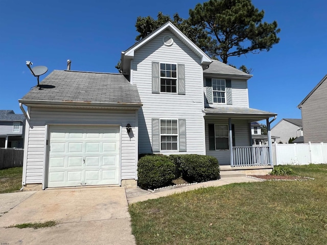 front of property featuring a garage, a front lawn, and covered porch