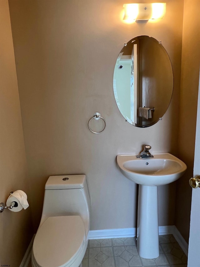 bathroom featuring tile patterned flooring, sink, and toilet