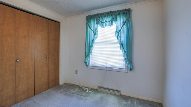 carpeted bedroom with a closet and a textured ceiling