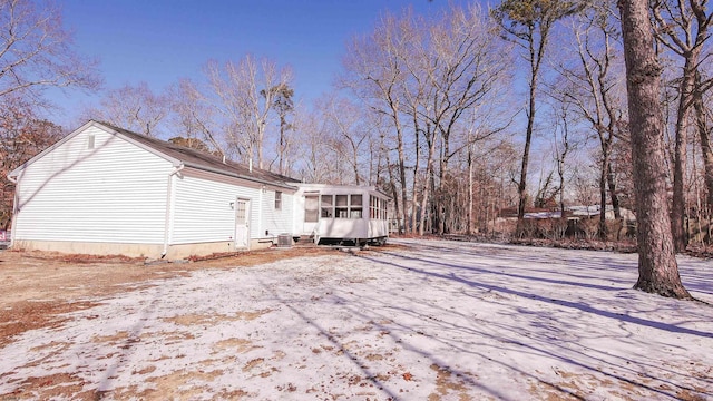 exterior space with a sunroom and cooling unit