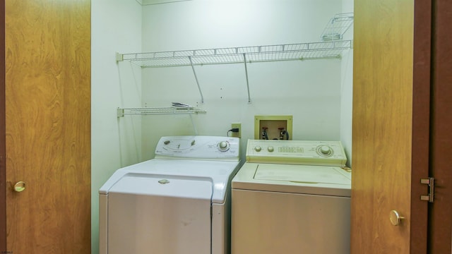 clothes washing area featuring washer and dryer