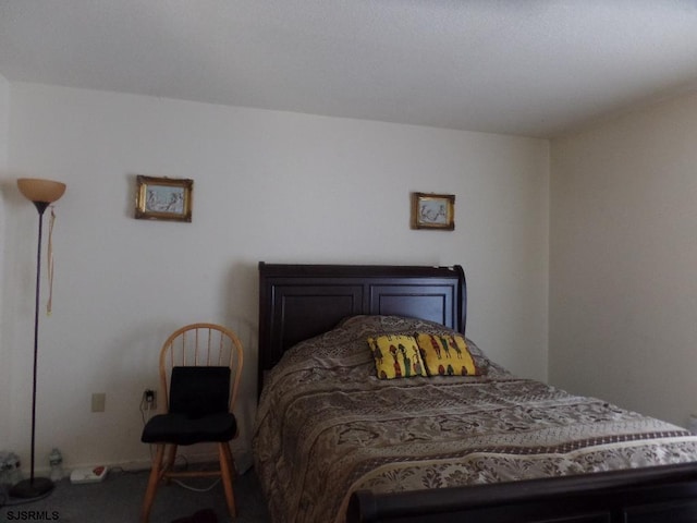 bedroom with dark carpet