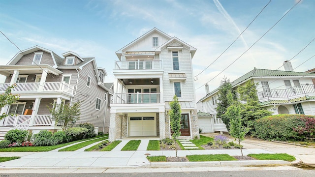 view of front of home with a balcony and a garage