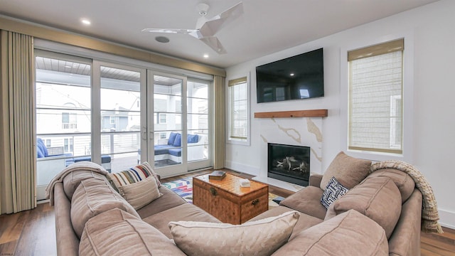 living room with hardwood / wood-style flooring, a fireplace, and ceiling fan