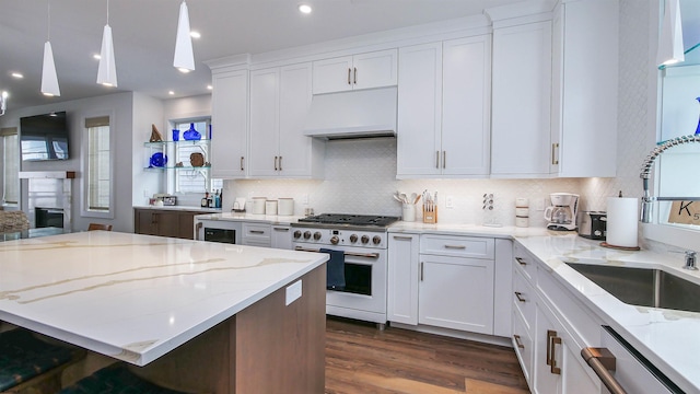 kitchen with dark wood-type flooring, light stone countertops, white cabinets, white gas range, and custom exhaust hood