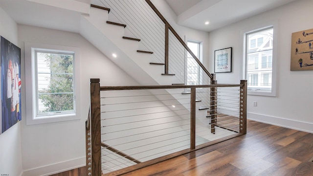 stairs featuring wood-type flooring