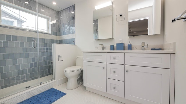 bathroom featuring walk in shower, vanity, toilet, and tile patterned flooring