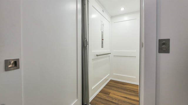 hallway with dark hardwood / wood-style floors