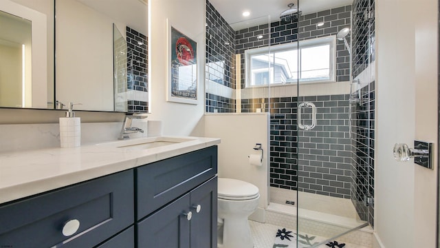 bathroom with tile patterned flooring, vanity, a shower with shower door, and toilet