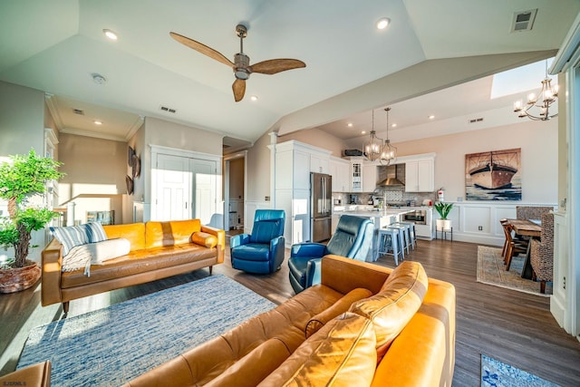 living room featuring lofted ceiling, ceiling fan with notable chandelier, crown molding, and dark hardwood / wood-style floors