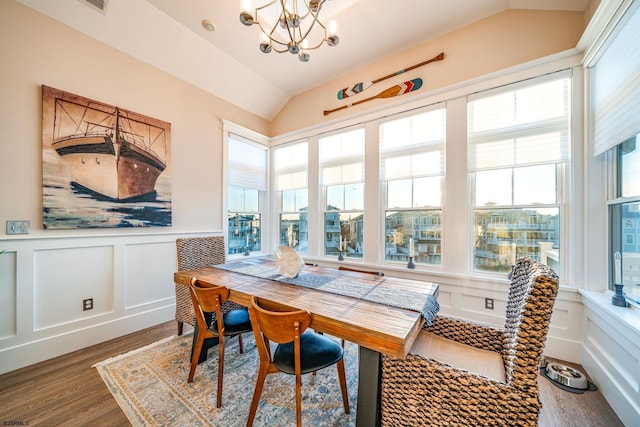 sunroom with lofted ceiling and a notable chandelier