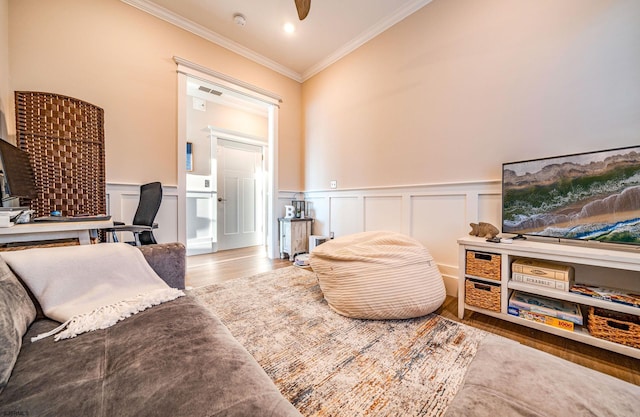 living area featuring hardwood / wood-style floors and ornamental molding