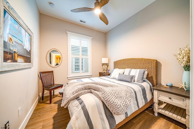 bedroom with light hardwood / wood-style floors and ceiling fan