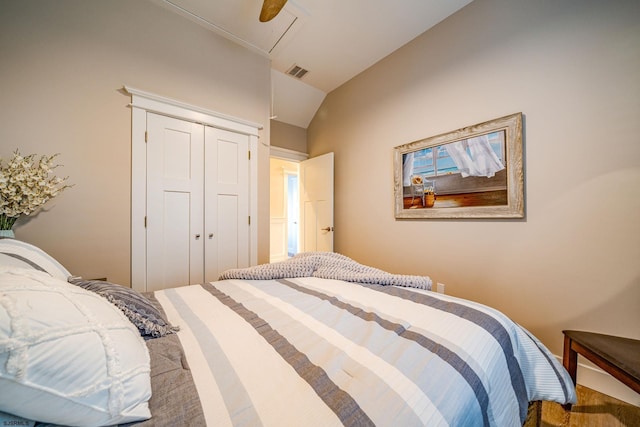 bedroom with vaulted ceiling, ceiling fan, and a closet