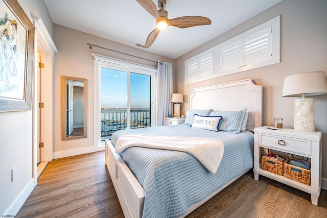 bedroom featuring ceiling fan, dark hardwood / wood-style flooring, and access to outside